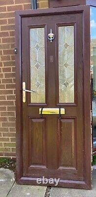 Rosewood wood effect composite front entrance door with silver accessories