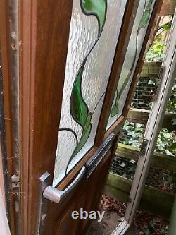 UPVC front door with a lovely tinted windows Roses? Pattern Oak Like Exterior